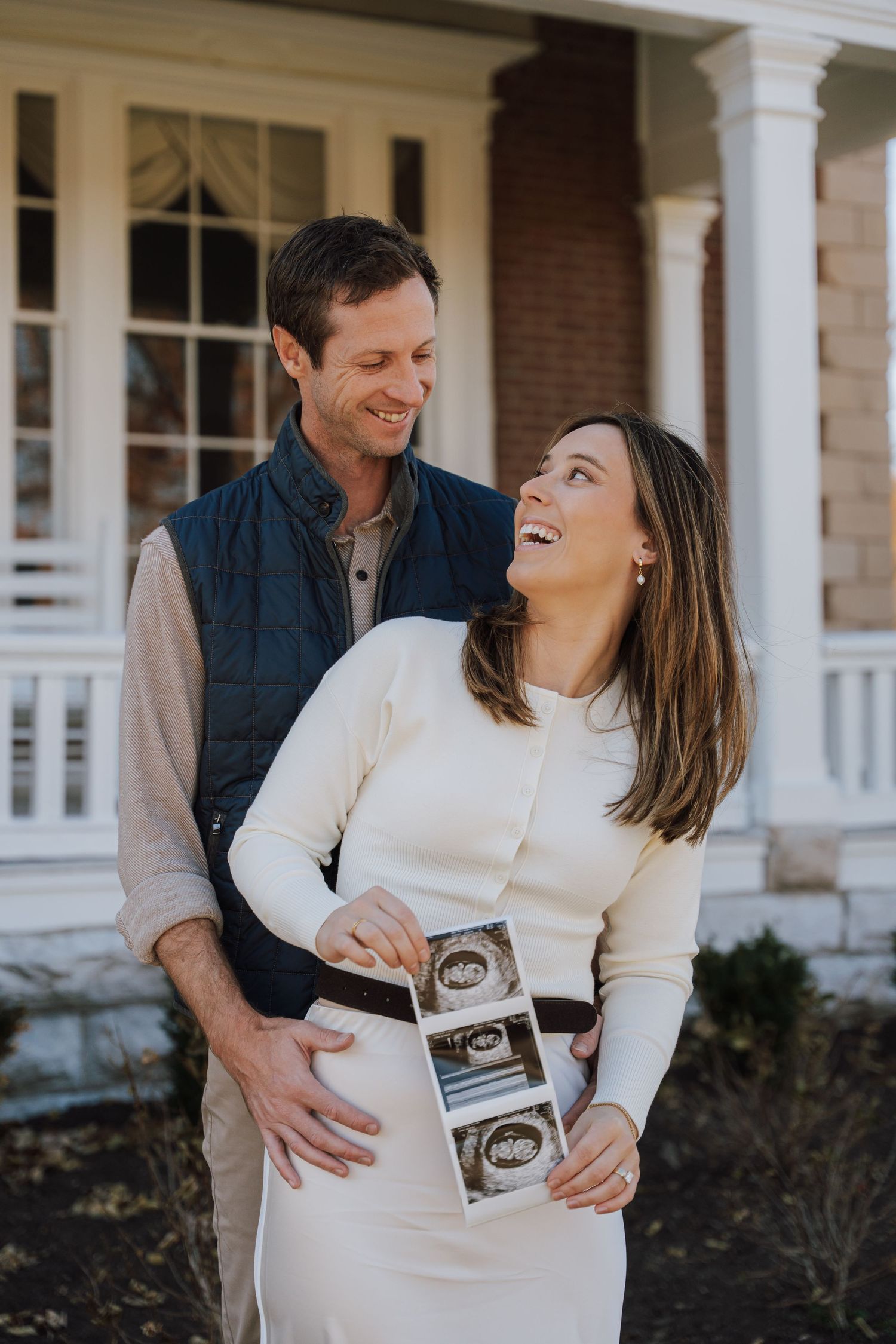 a couple holding a sonogram strip