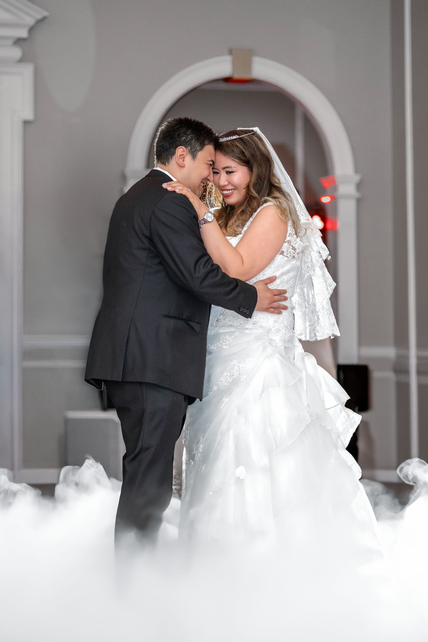 Romantic collage of newlyweds dancing in clouds of white fog during their first dance at an elegant wedding reception.