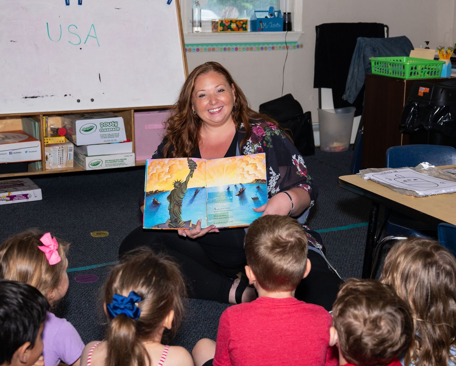 Students sit in a classroom while engaged in a learning activity at their desks.