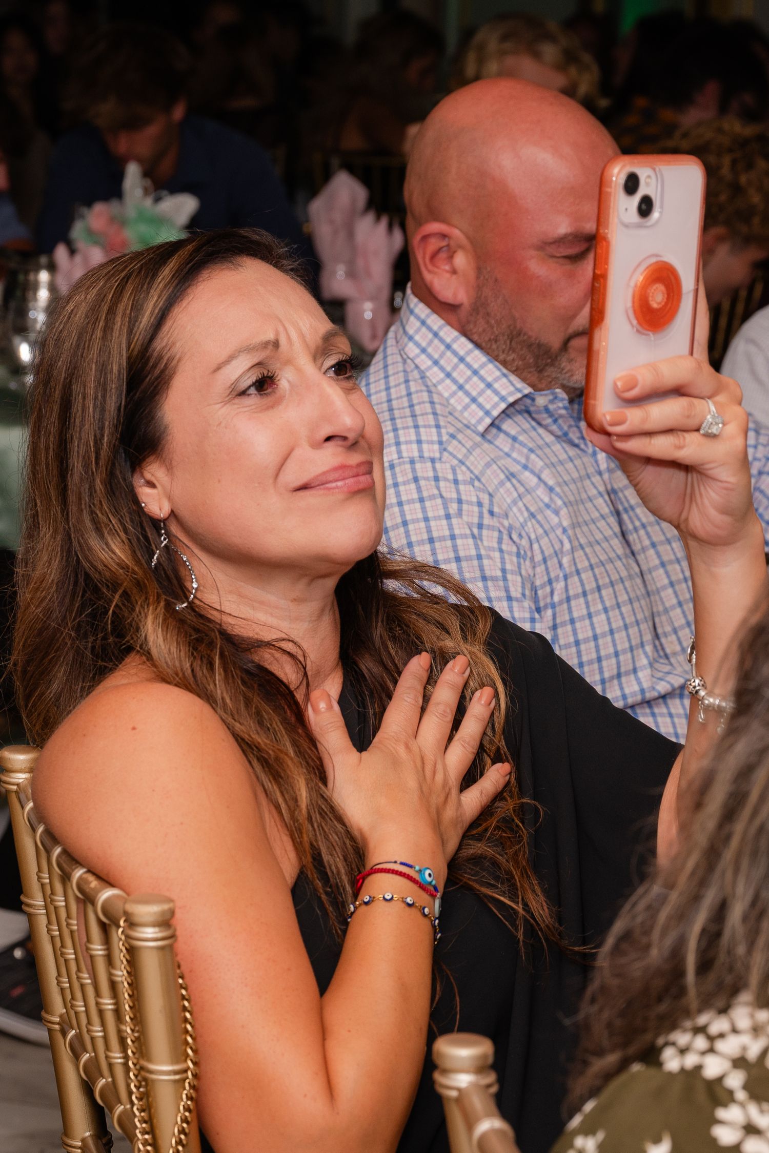 Candid party moments captured at indoor social gathering.