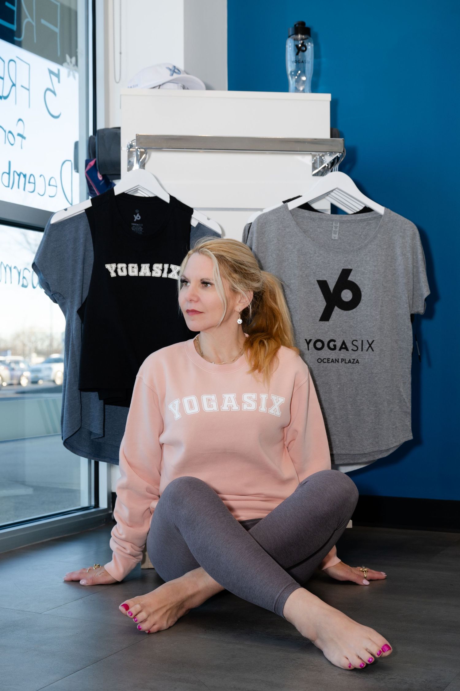 Yoga studio retail display with branded apparel and merchandise.