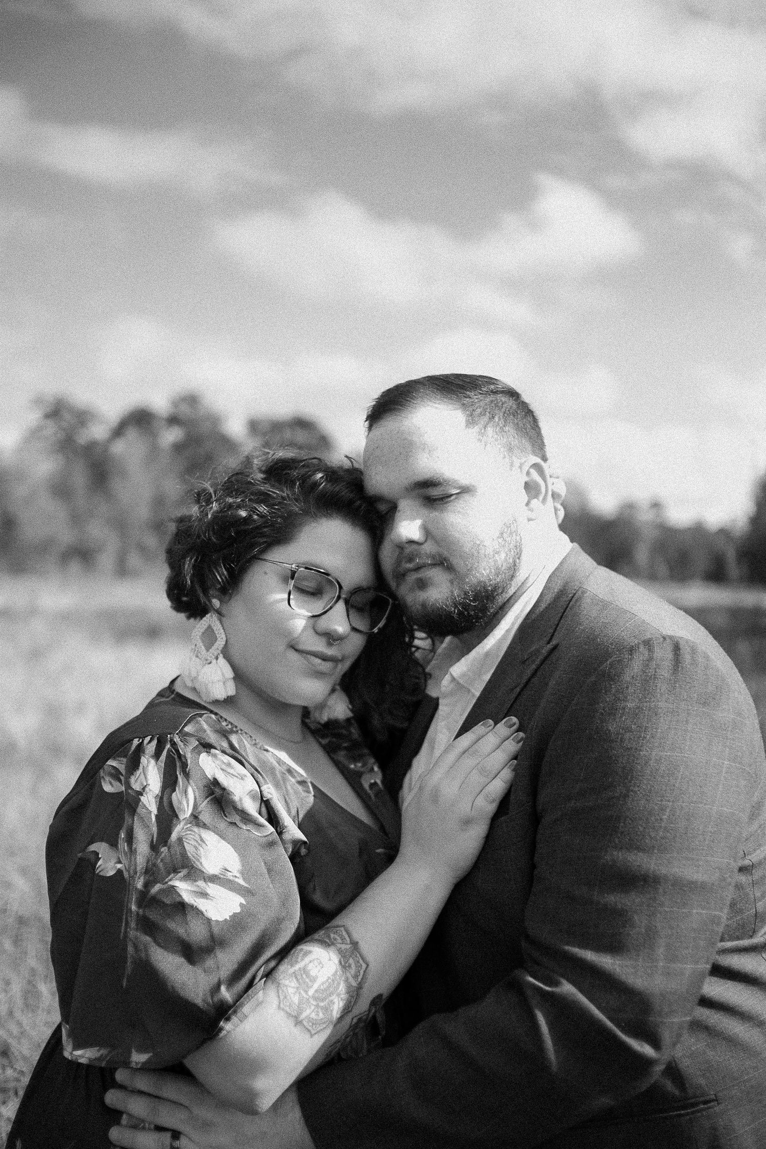 Romantic outdoor portrait session in a field on a cloudy day.