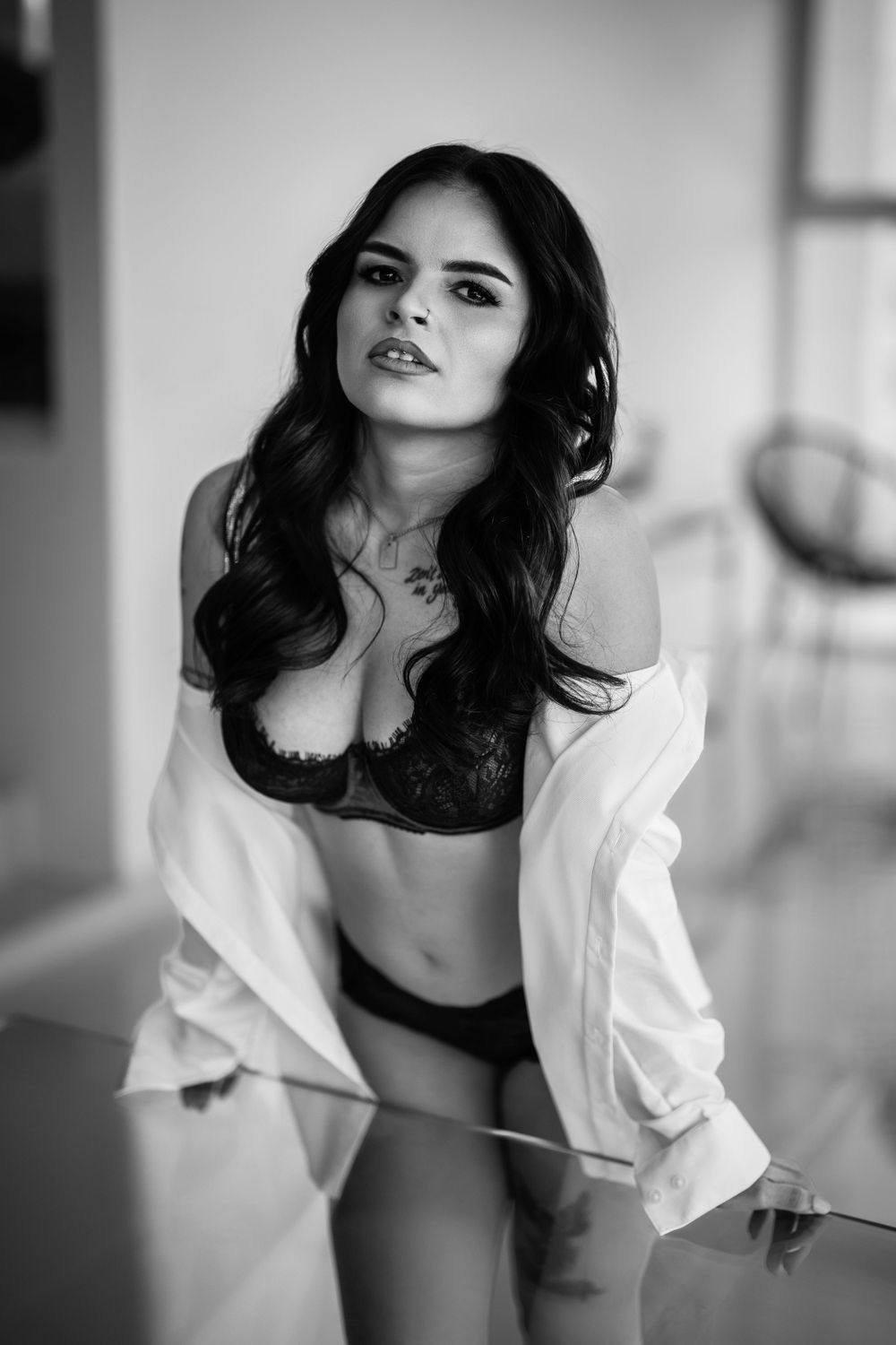 Black and white boudoir photography series showing artistic poses in white button-down shirt and lingerie.