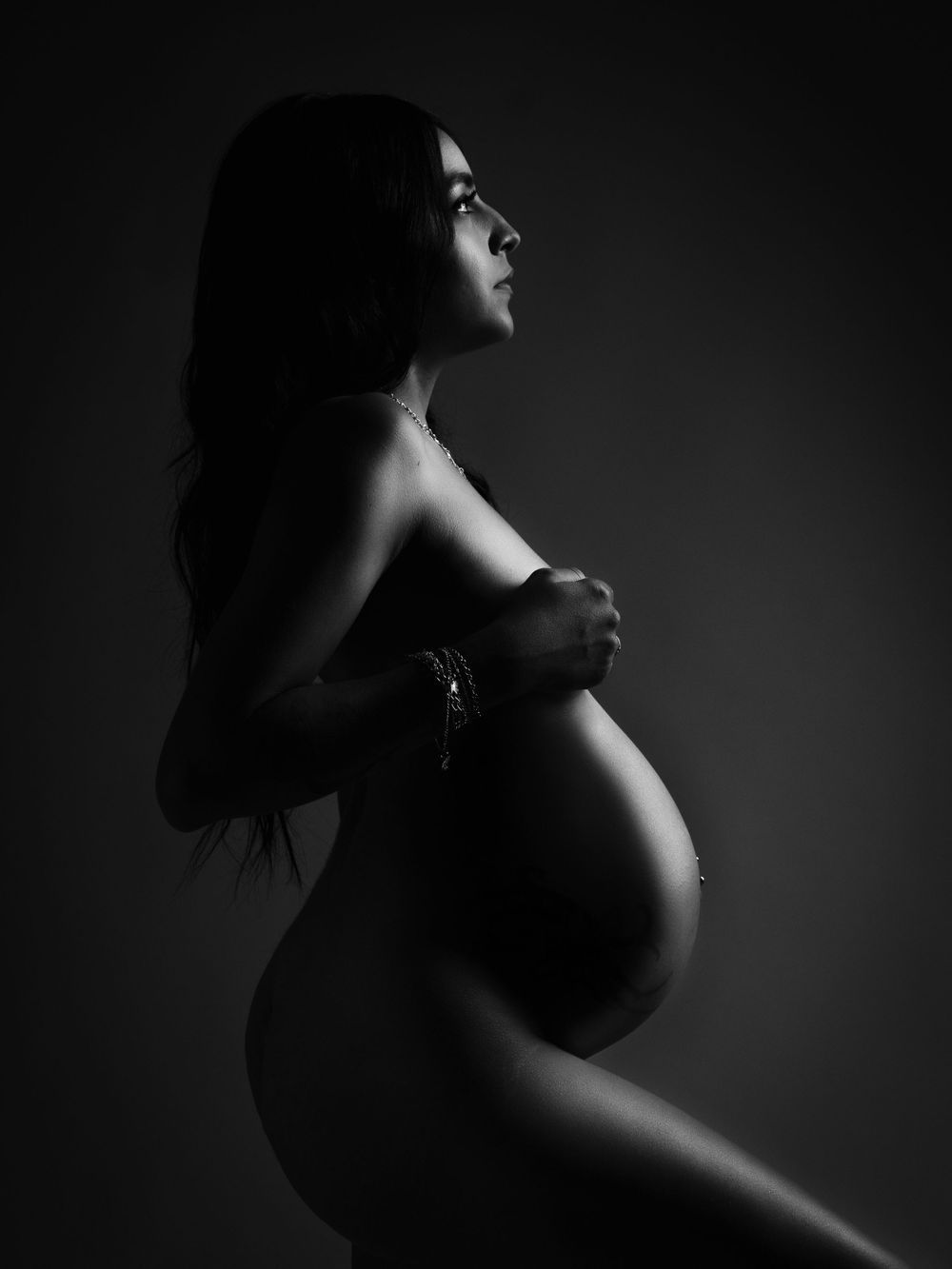 Dramatic black and white artistic portraits with moody side lighting.