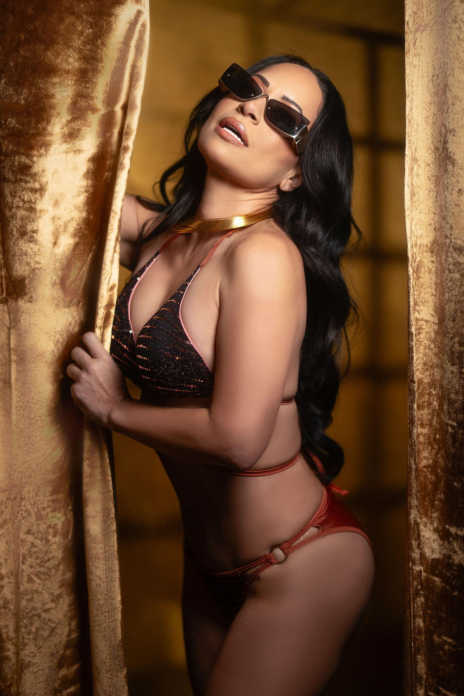 Intimate portrait series with velvet curtains and warm golden lighting.