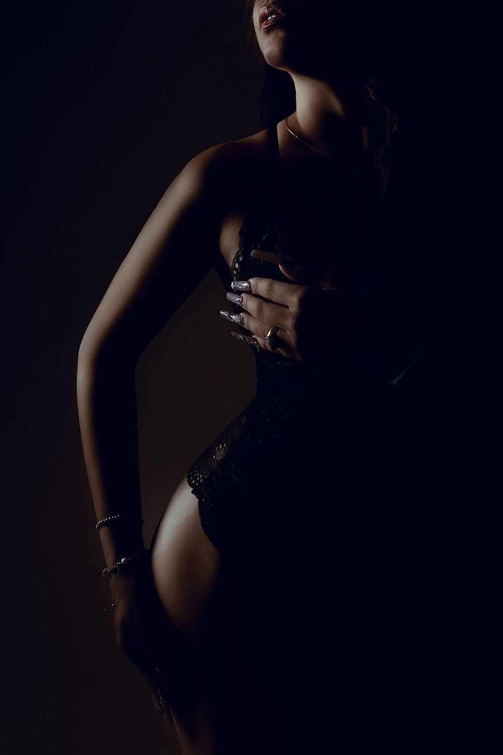 Silhouette figure study with dramatic shadows and minimal lighting.