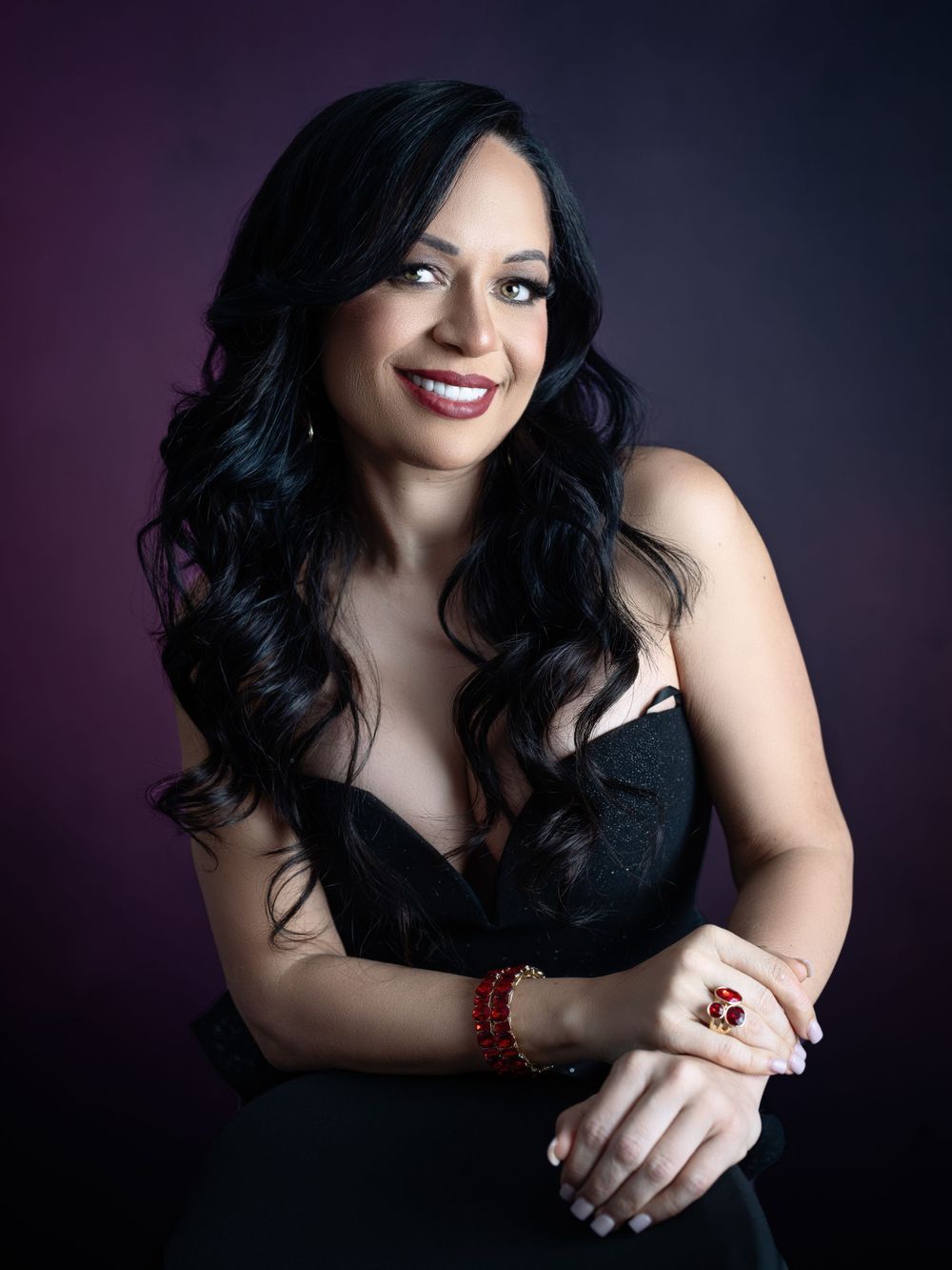 Artistic boudoir portrait series featuring dark curly hair and dramatic purple lighting.