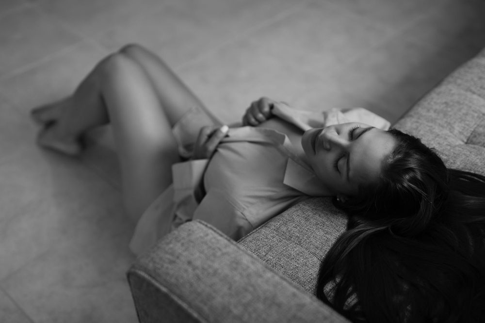 Dramatic black and white boudoir photography with moody lighting.