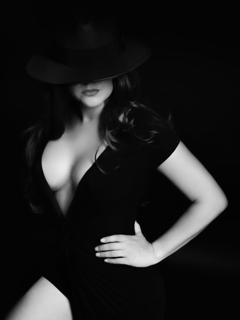 Film noir inspired portrait with classic lighting and dark shadows.