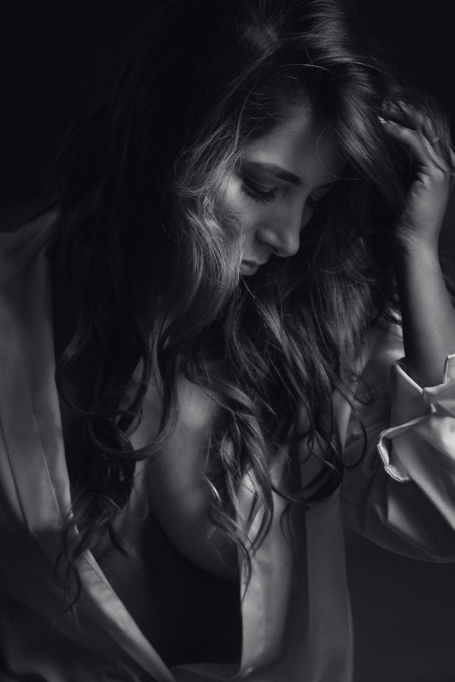 Artistic black and white portrait series showing dramatic shadows and flowing hair movement.