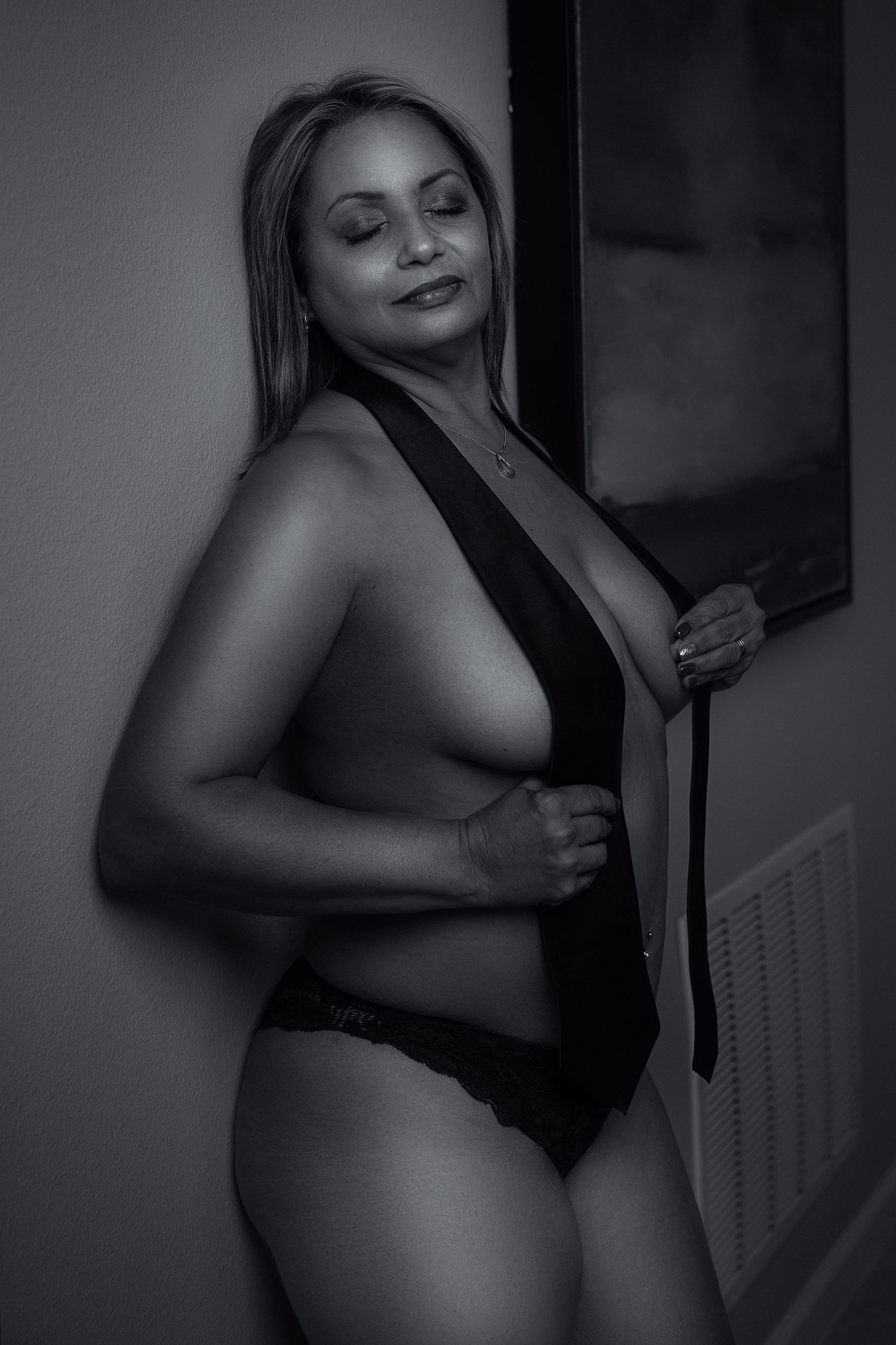 Intimate black and white photography series with dramatic lighting and poses.