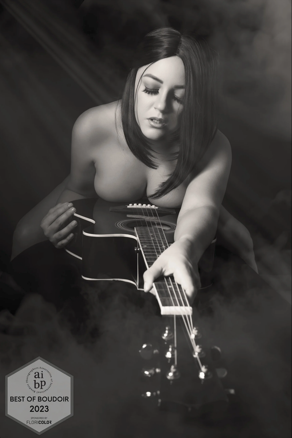 Black and white artistic photos of acoustic guitar with award badge visible.