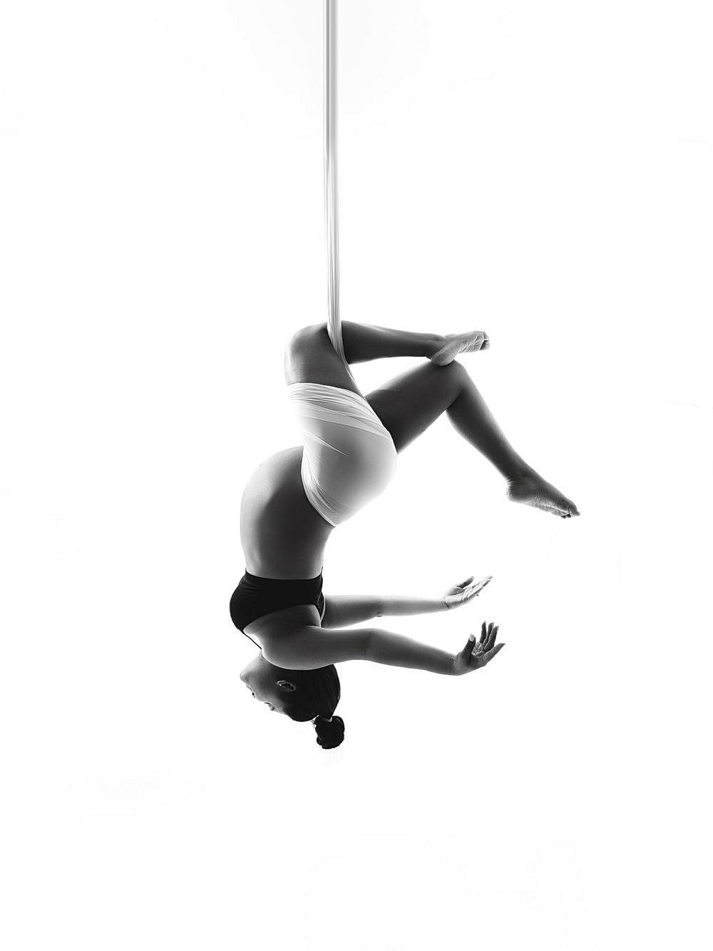 Minimalist black and white photos showing aerial dance movements in sequence.