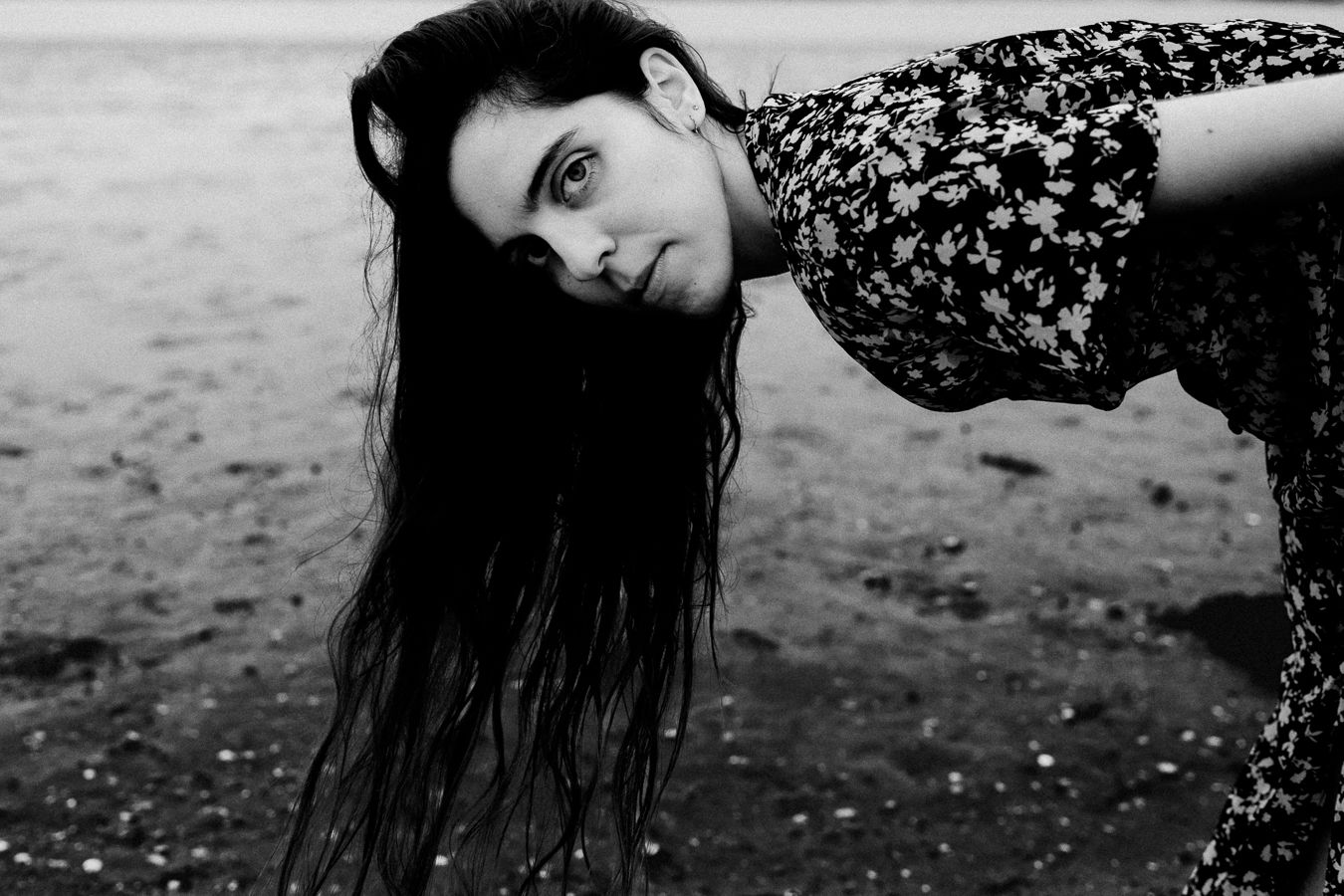 Dramatic black and white portrait with long dark hair in motion.