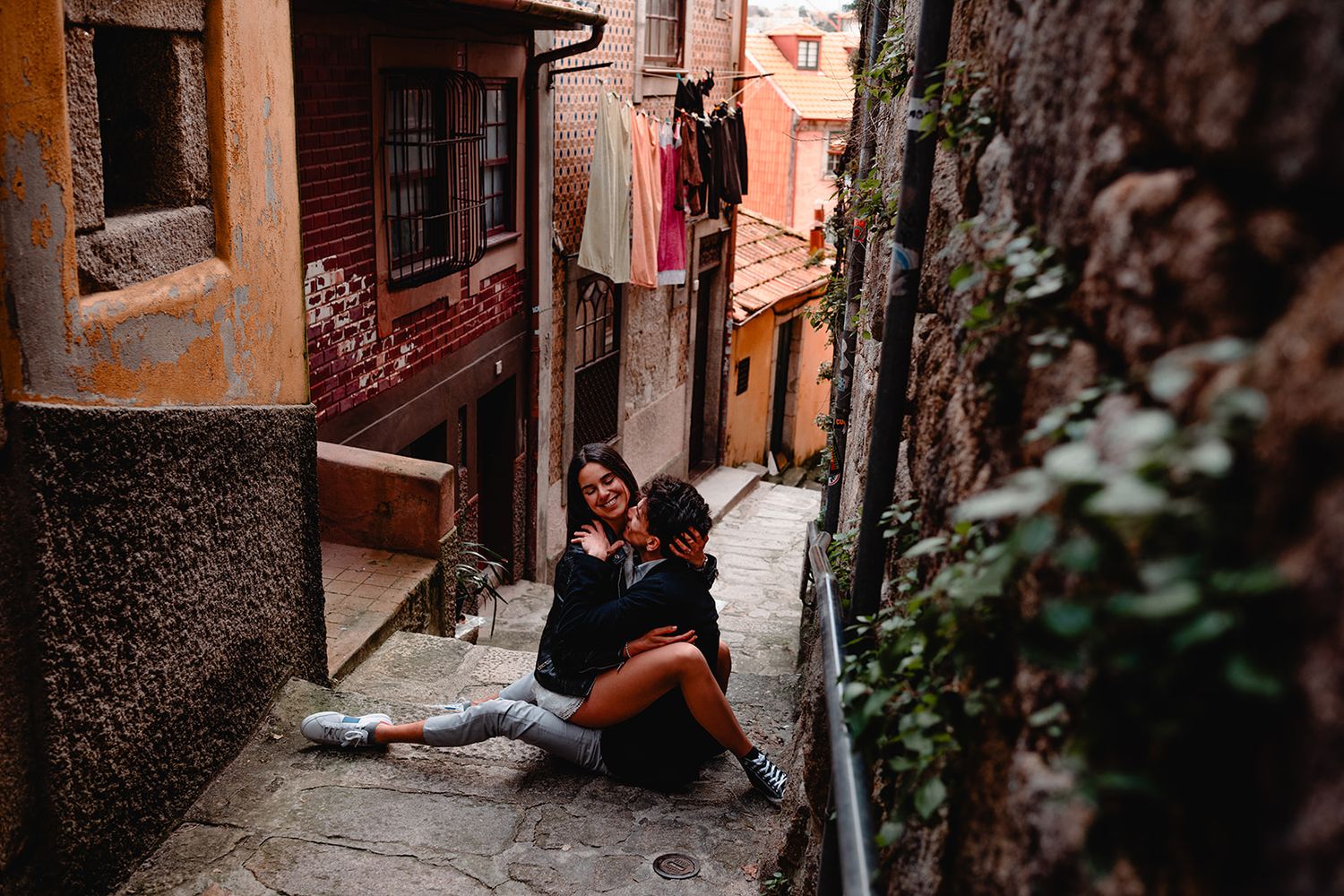 Narrow alleyway with rustic orange walls and traditional architecture in a Mediterranean setting.