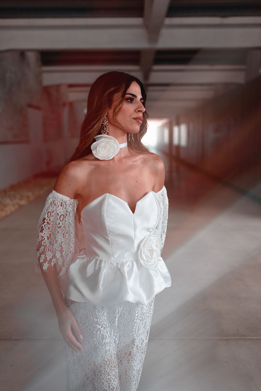 A bridal gown with delicate lace overlay features off-shoulder details and romantic sweetheart neckline.