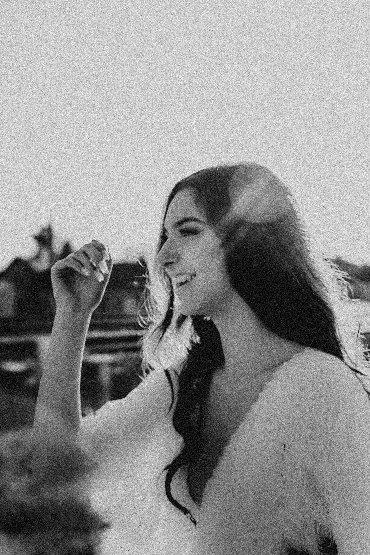 Artistic black and white portrait with ethereal backlighting and dramatic pose.