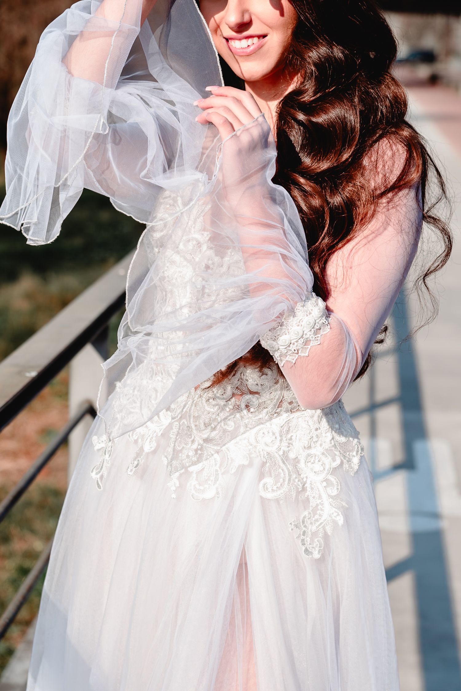 Close-up details of intricate lace wedding dress with soft natural lighting.