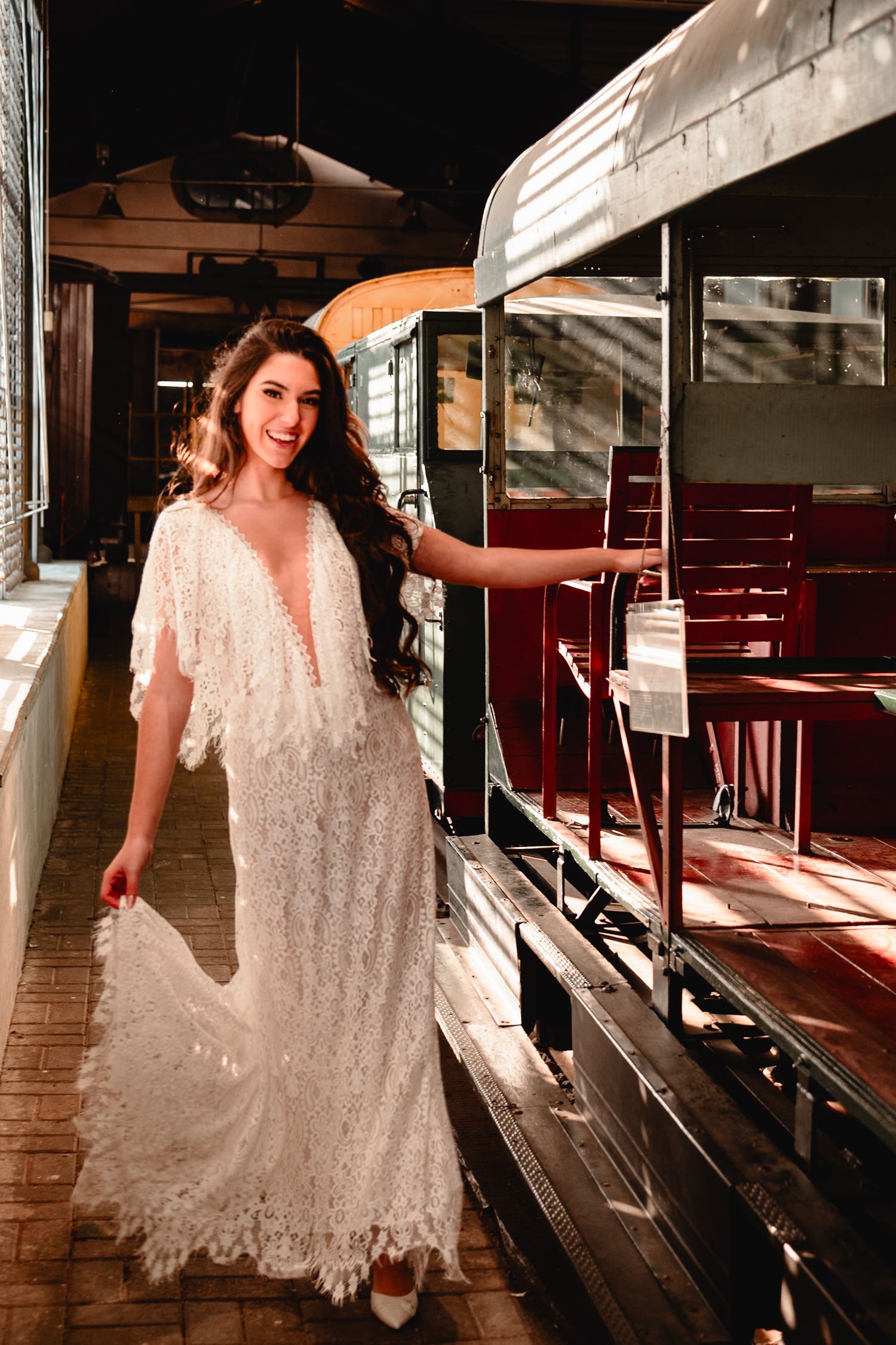 Ethereal bridal photography session inside historic train car with natural lighting.