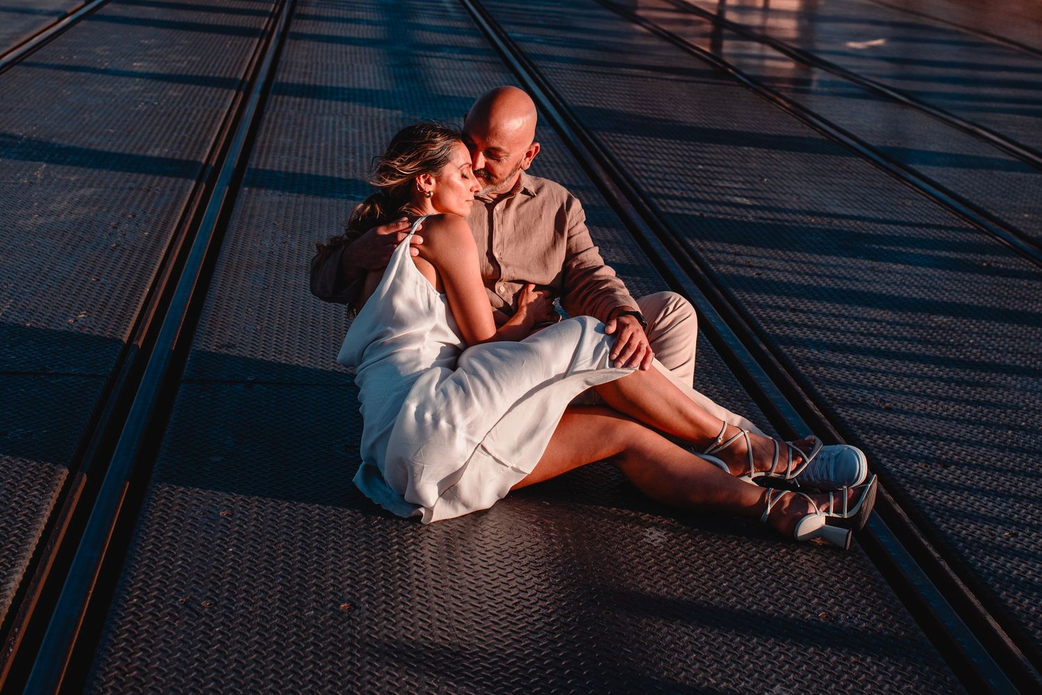 Artistic series of sunset silhouettes showing affectionate moments on a balcony.