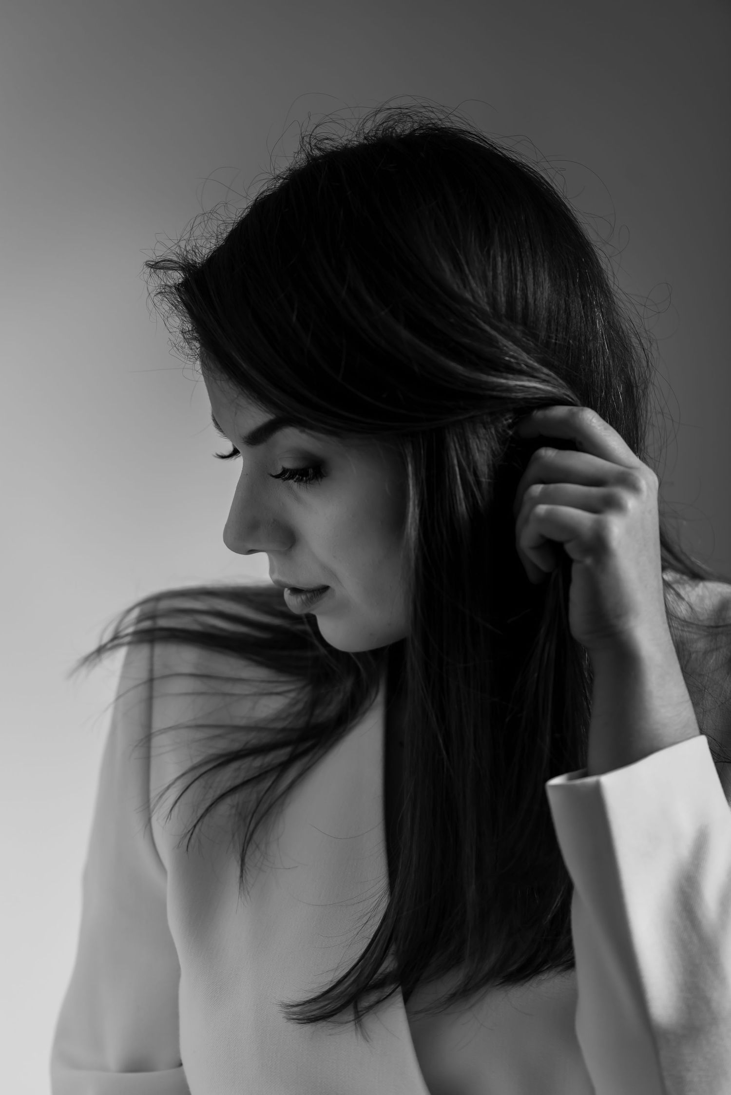Minimalist black and white portrait series capturing flowing hair movement.