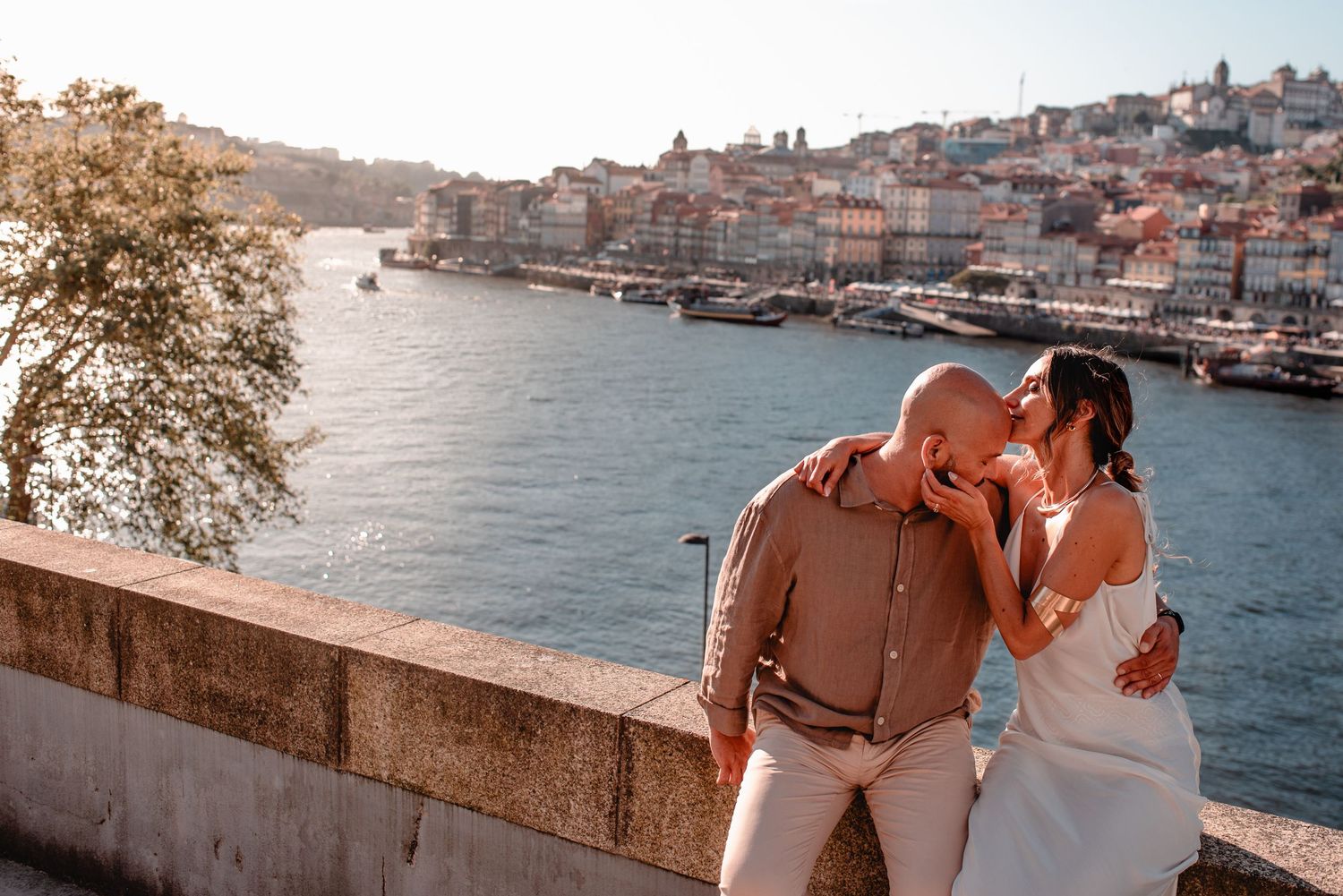 Romantic portrait session along Porto's scenic riverside at sunset.