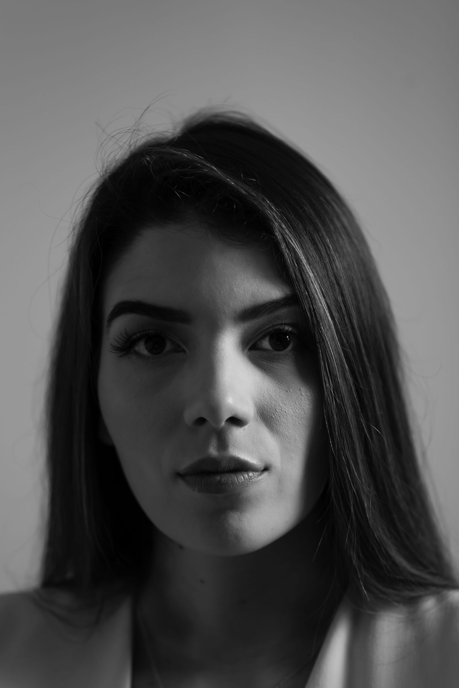 Dramatic black and white close-up portrait series with moody lighting.