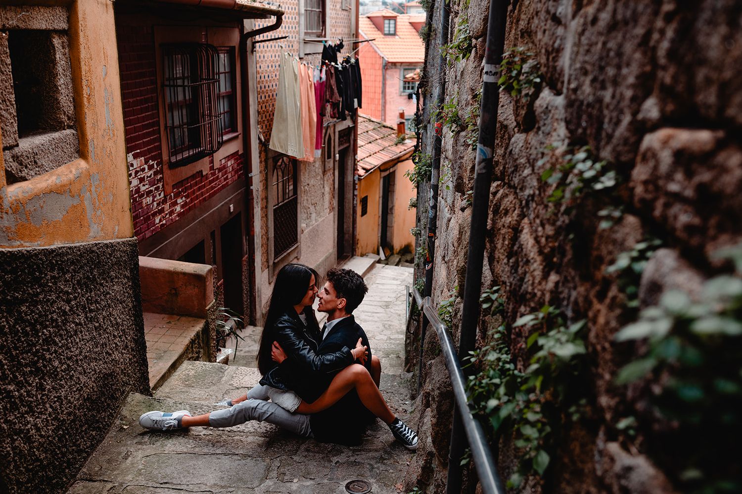 Candid moments captured along rustic stone steps in European village setting.