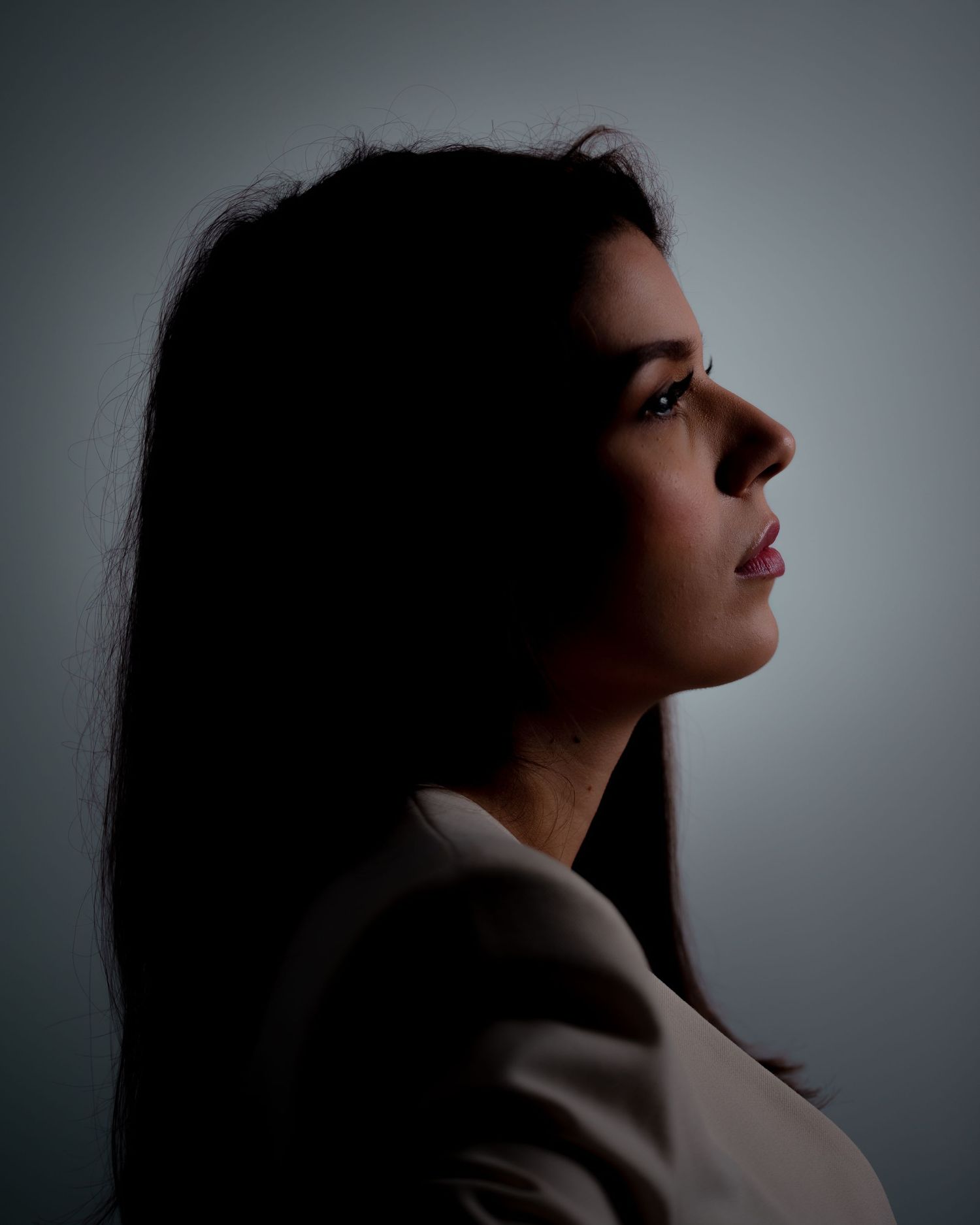 Dramatic silhouette portraits in profile against moody lighting.