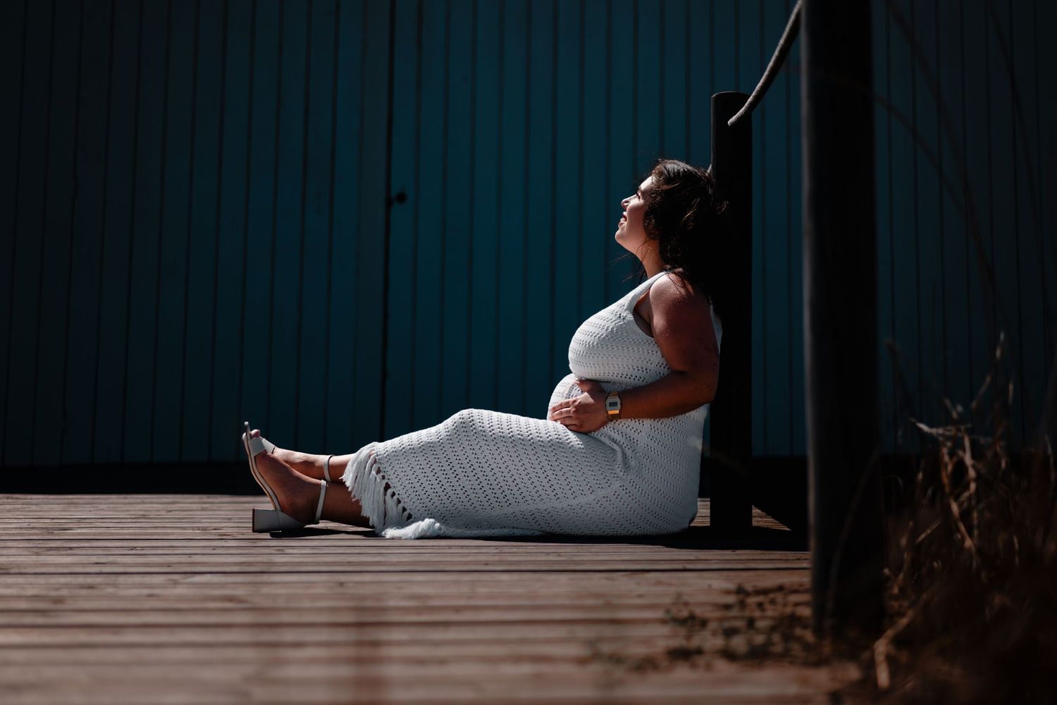 Artistic silhouette photography on wooden deck against dark background.