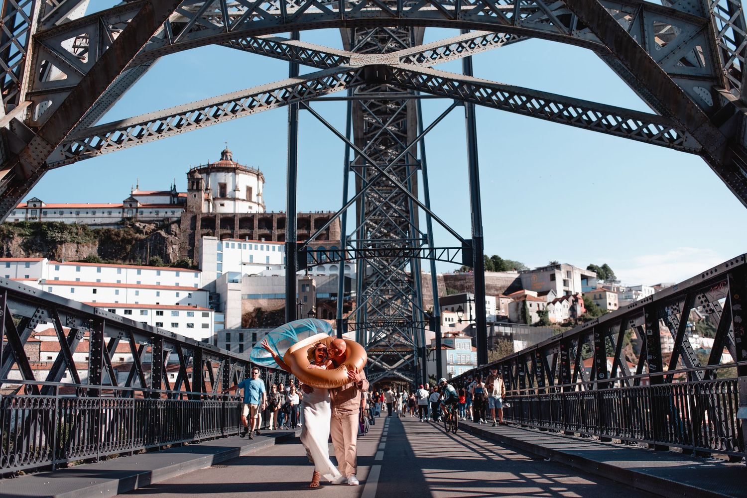 Panoramic view of Porto's iconic metal bridge structure under blue skies.