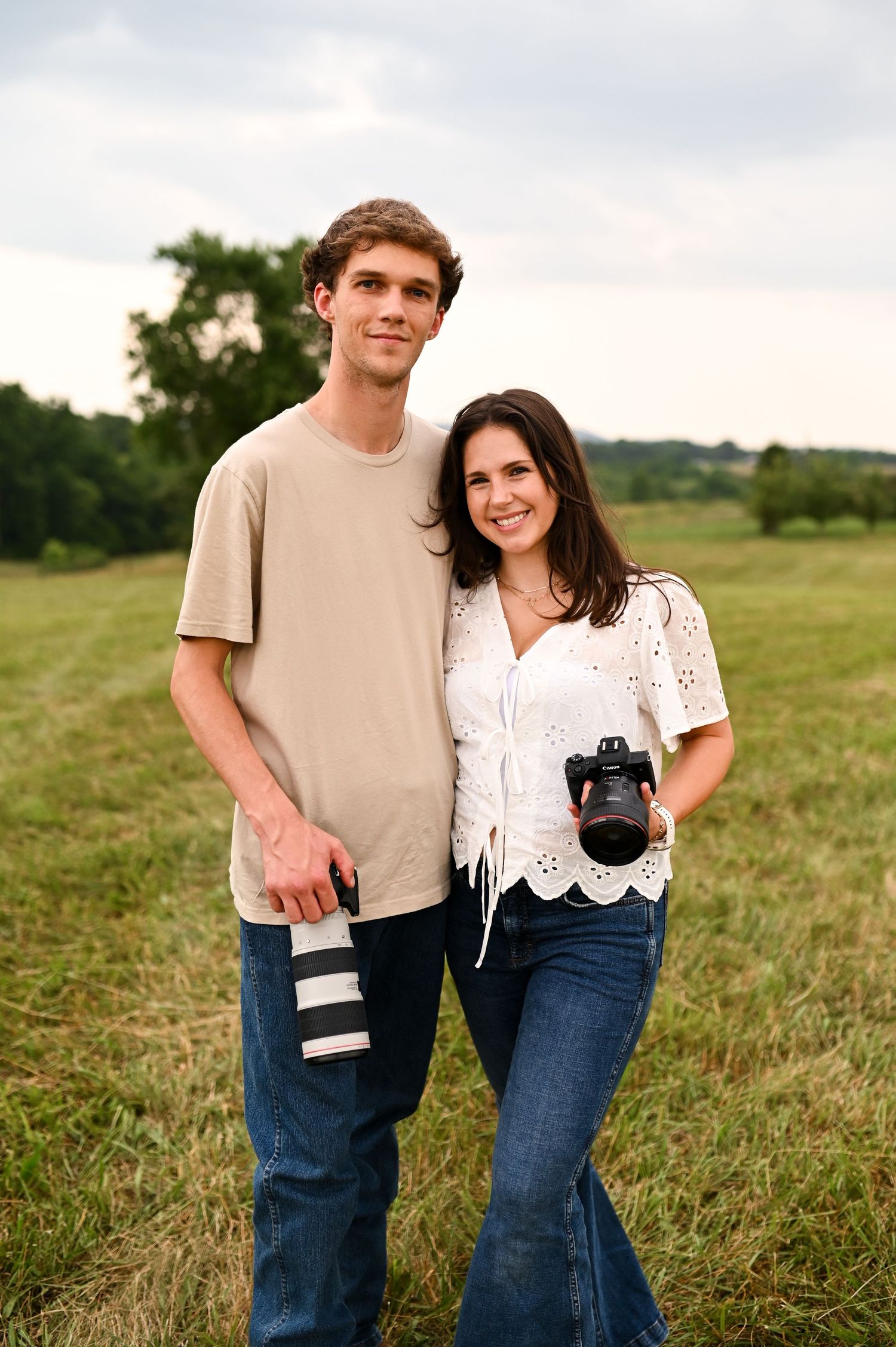 Couple standing together in a field during golden hour for a candid lifestyle or engagement photoshoot in NC