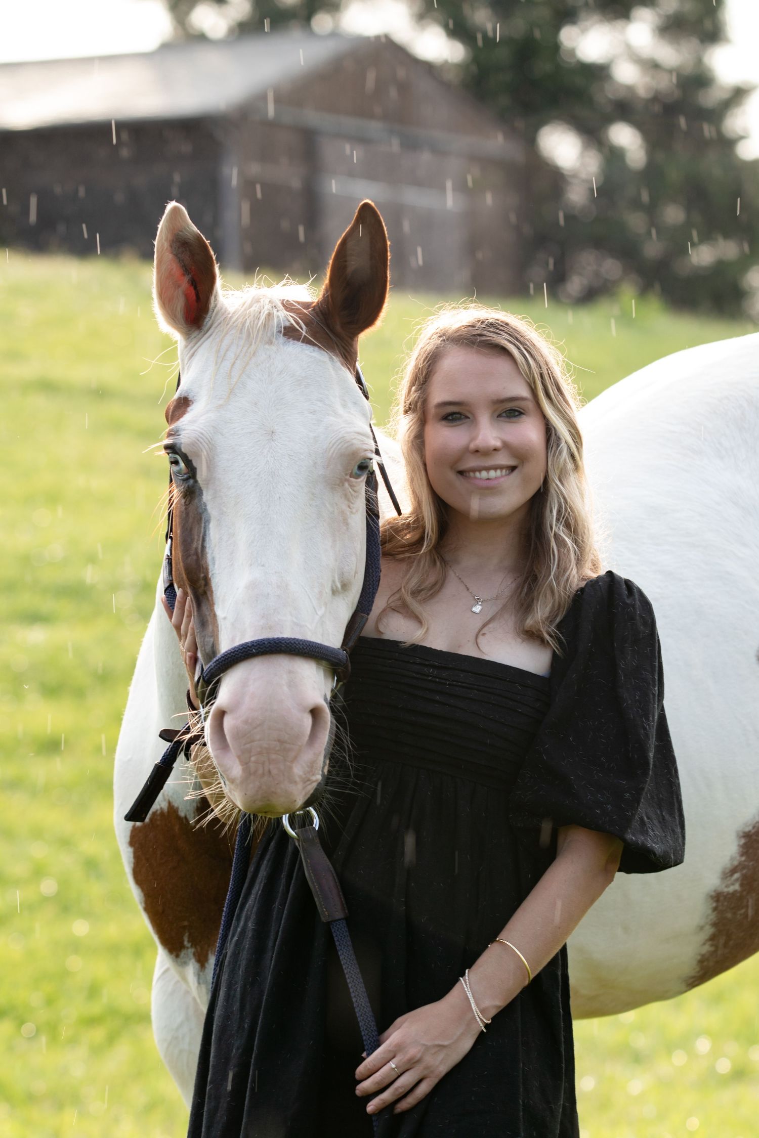 Equestrian girl smiling with her white horse during a summer horse photography session in NC