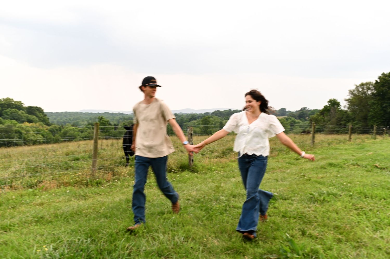 Playful outdoor engagement session in open field with NC couples photographer