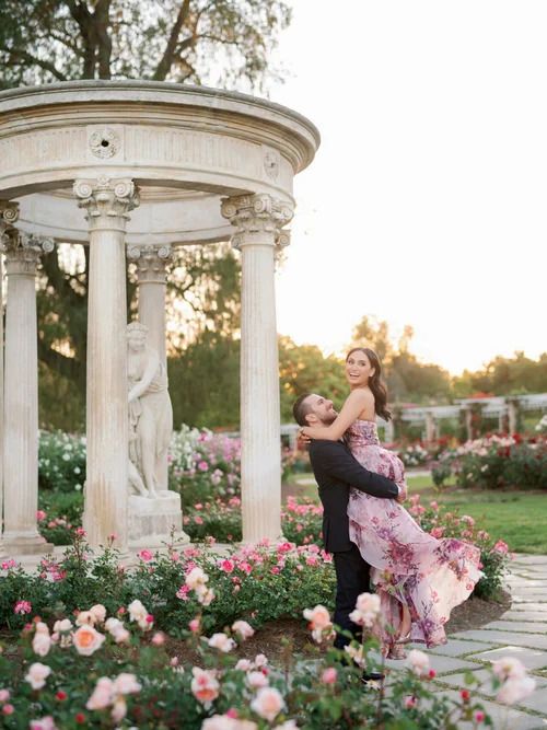 Romantic scene in a classical garden gazebo surrounded by blooming roses.