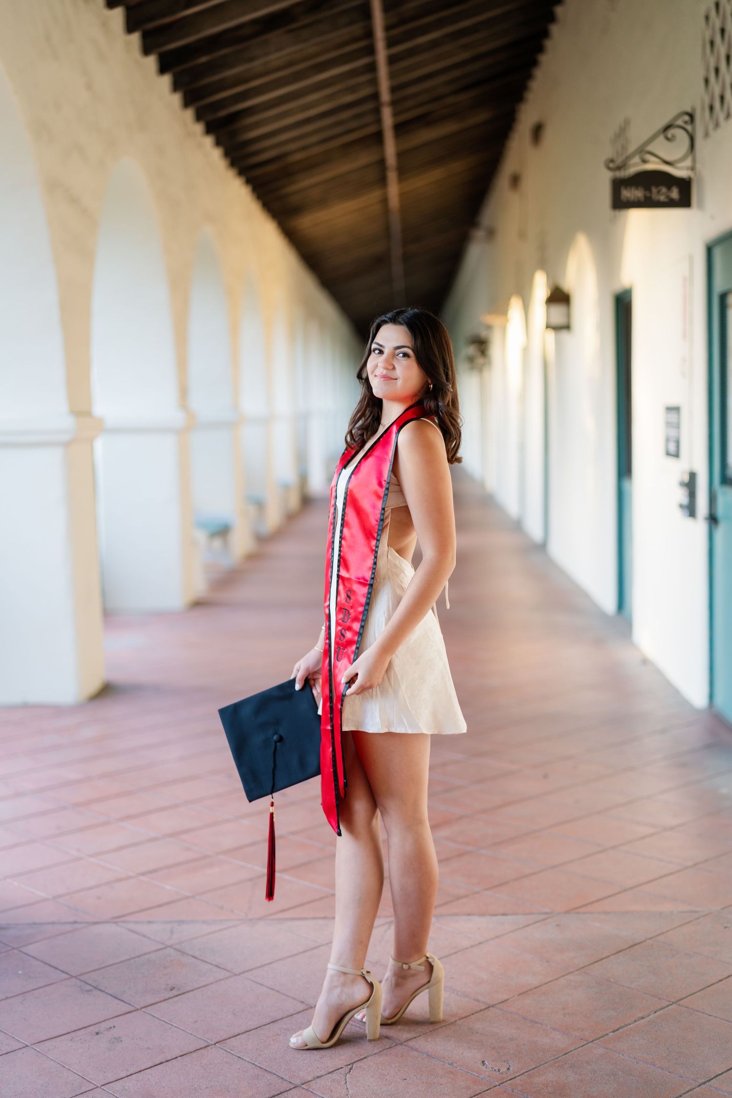 Series of photos in a long Spanish-style corridor with white columns and terracotta flooring.