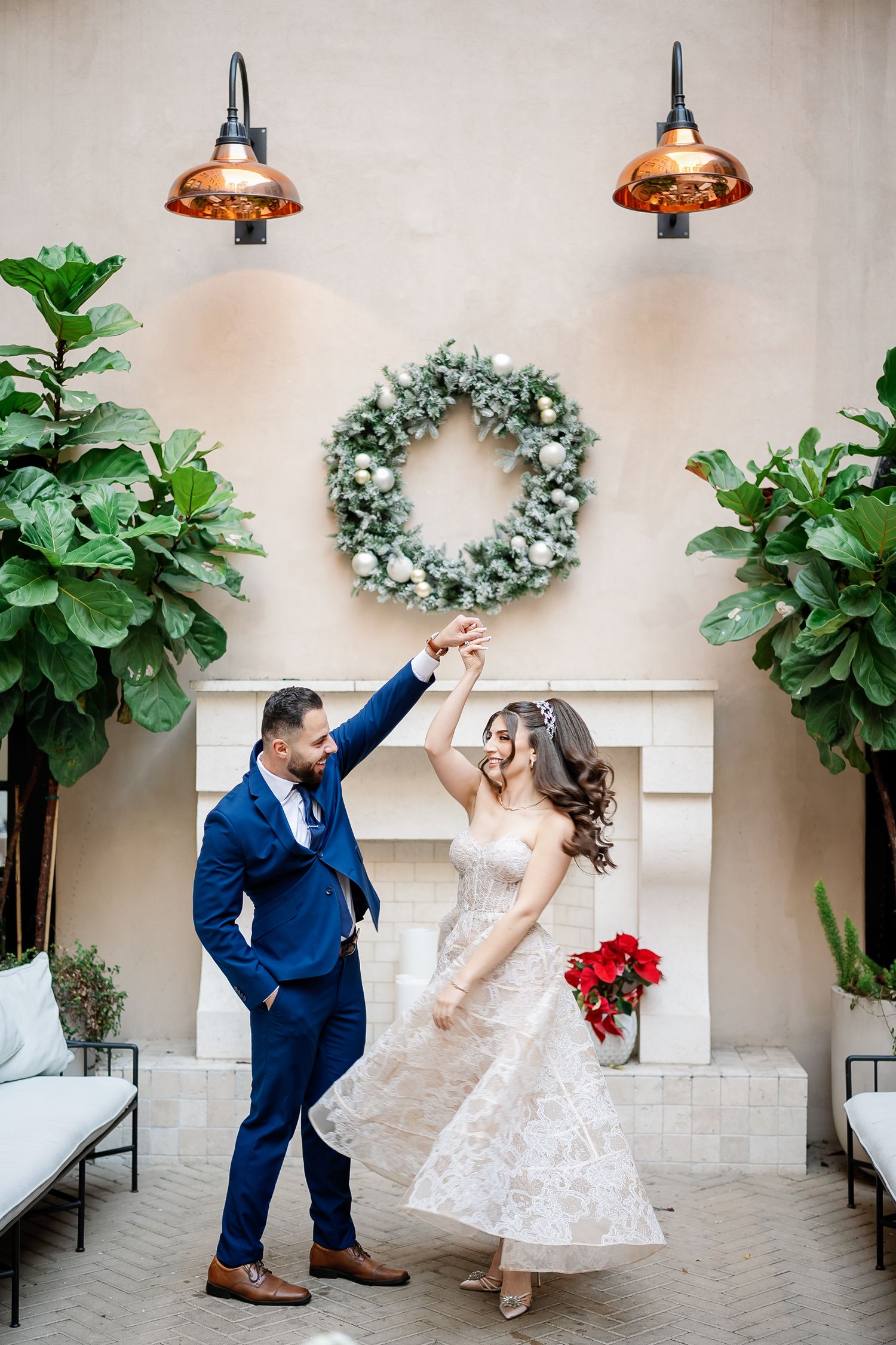 Joyful celebration moment in an elegant courtyard with hanging lights and greenery decor.