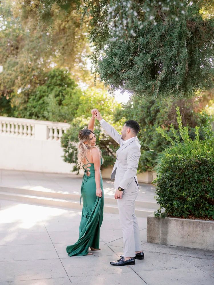 Two people perform a graceful dance sequence on an elegant white stone patio.