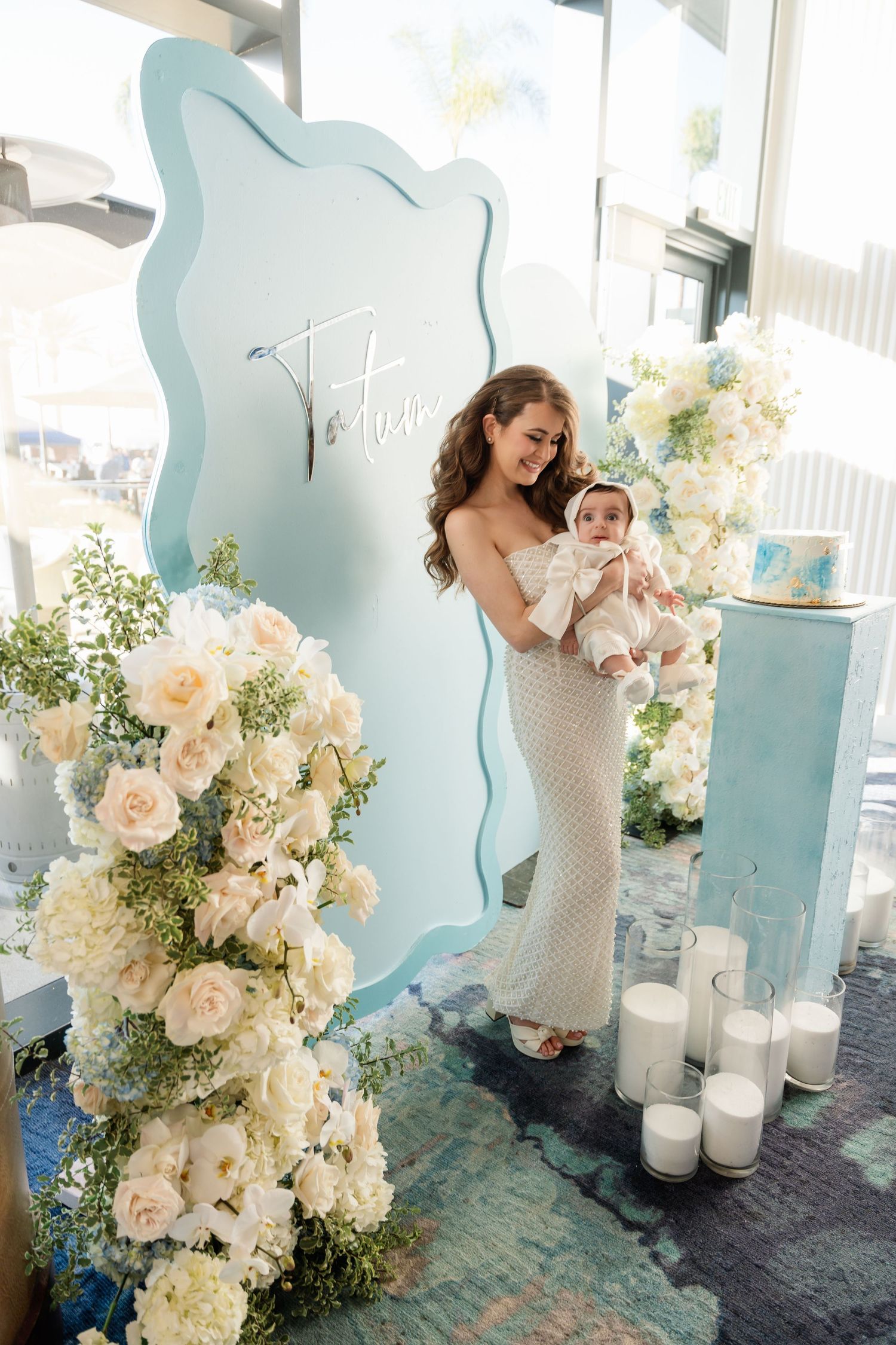 A series of candid moments at an elegant wedding celebration with white floral arrangements and soft blue decor elements.