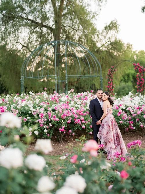 Romantic photoshoot in a garden with pink and white roses blooming.