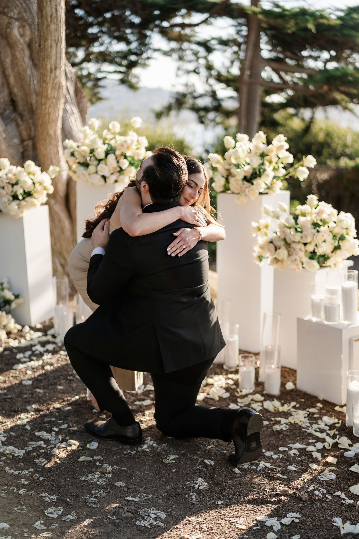 An emotional embrace captured during a surprise outdoor proposal.