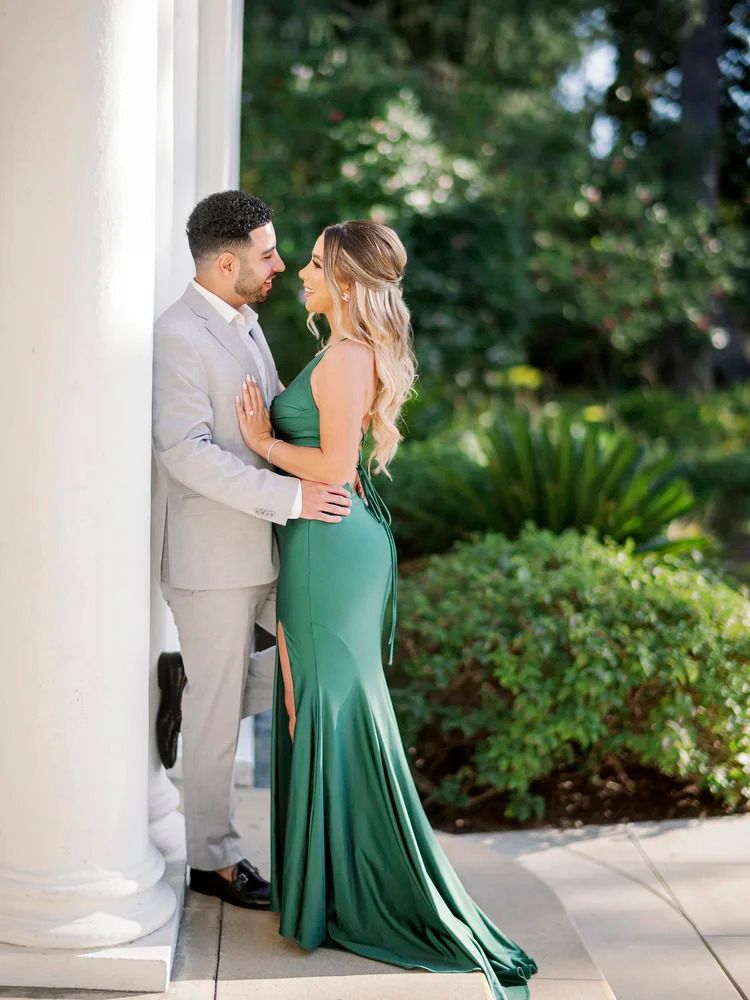 A romantic dance sequence shows a couple in green and grey formal wear on an outdoor terrace.