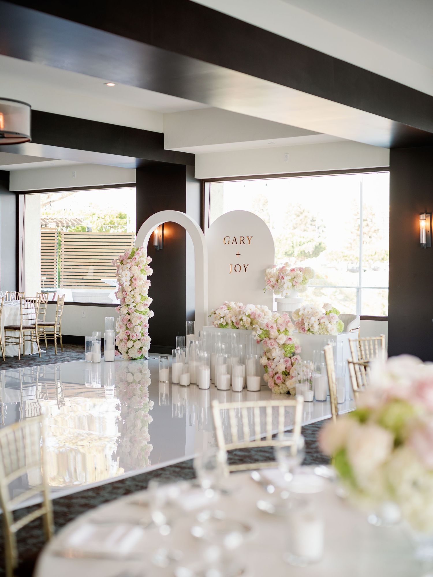 Clean modern reception space with white floral centerpieces and contemporary black and white decor.