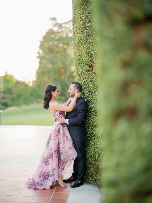 Intimate moment captured against lush green garden foliage.