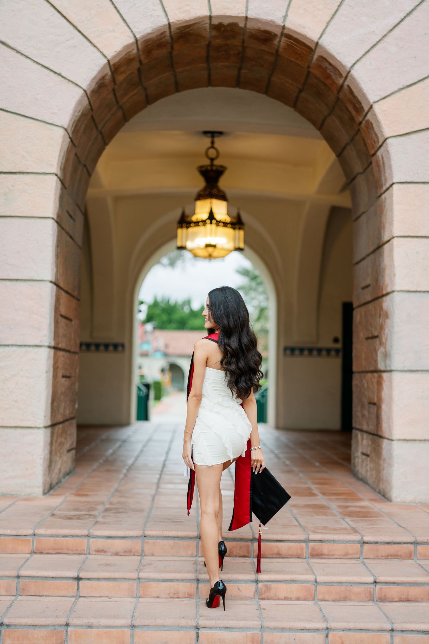 A sequence of photos taken in an elegant stone archway corridor with pendant lighting.