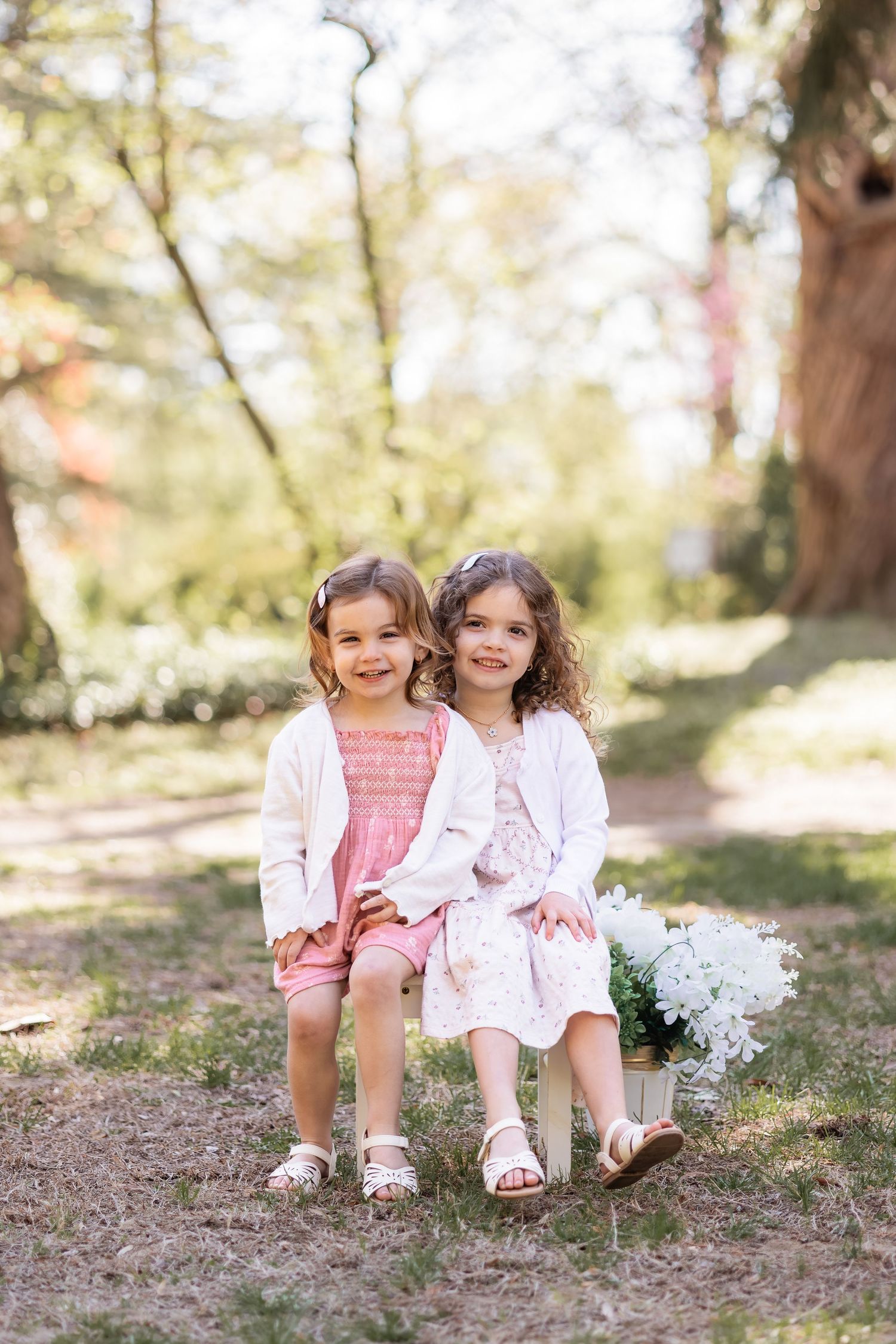 Two sisters sitting together for a sibling family portrait Crofton Maryland
