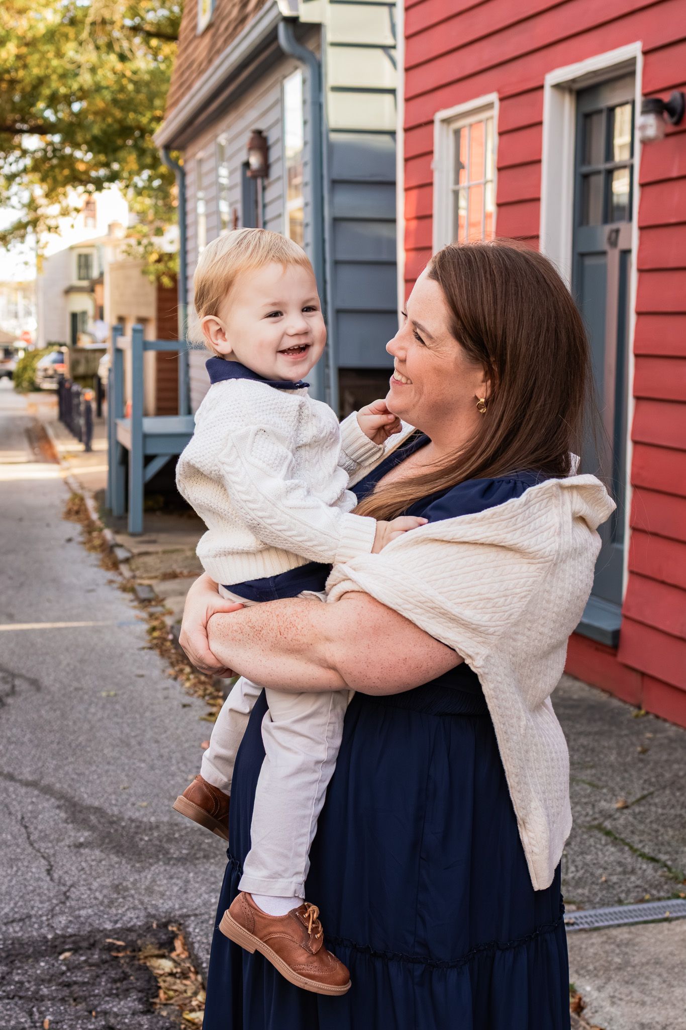 Mom holding her son in Downtown Annapolis during a fall family photography session.