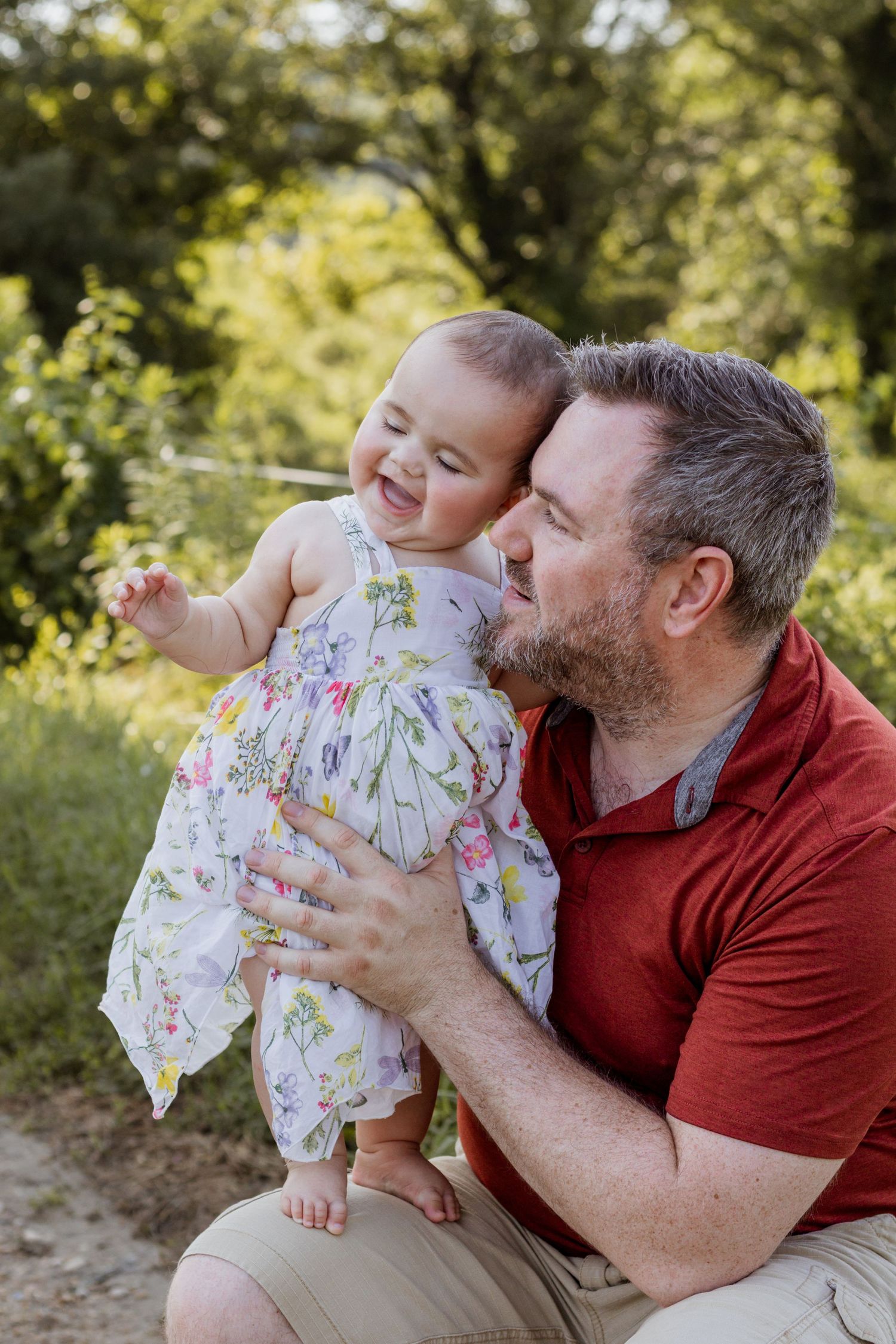 Father holding his daughter during a morning horse farm family lifestyle photography session in Gambrills, Anne Arundel County, Maryland