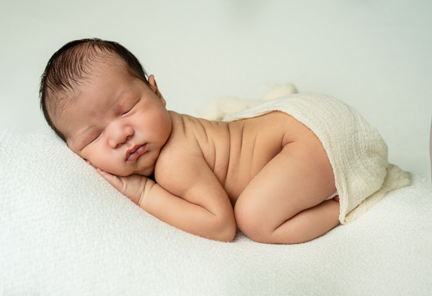 Baby boy in white newborn photography. Best newborn photographer in Cypress, CA. Orange county photo of Boy sleeping.