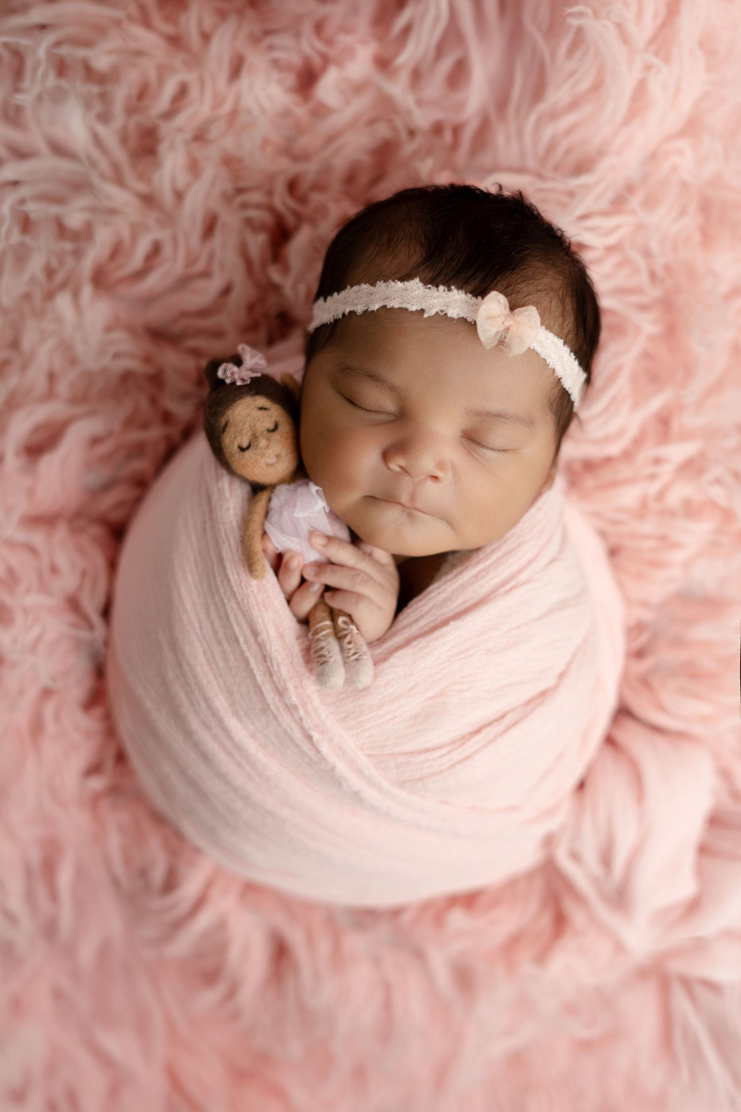 Pretty in pink girl - Newborn photography. She looks so sweet in her ballet image with her doll in pink. Best newborn photographer in Brea